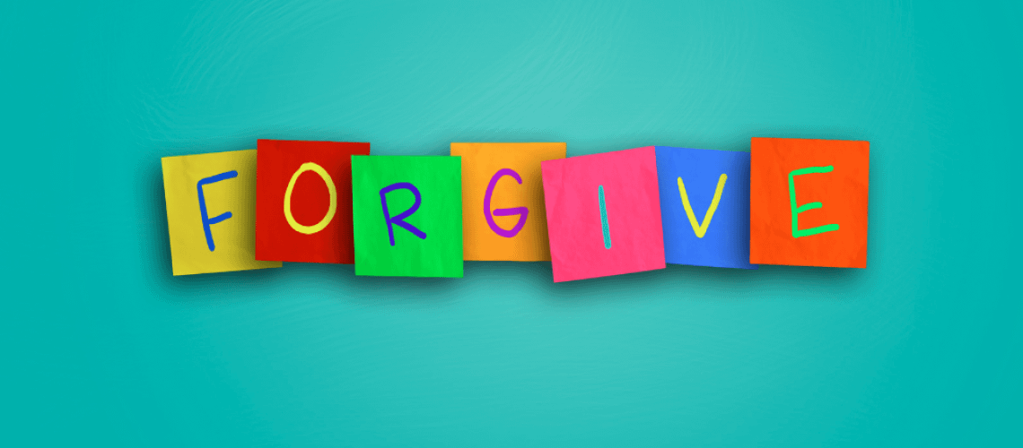 The word forgive written on sticky colored paper