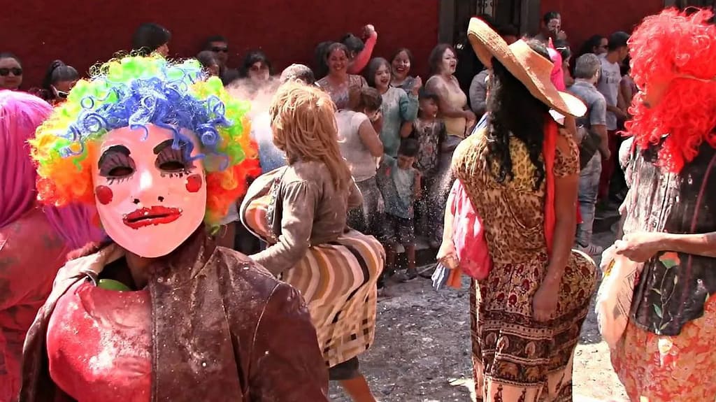 The sayacas, men dressed as women throw flour at people at the carnival.